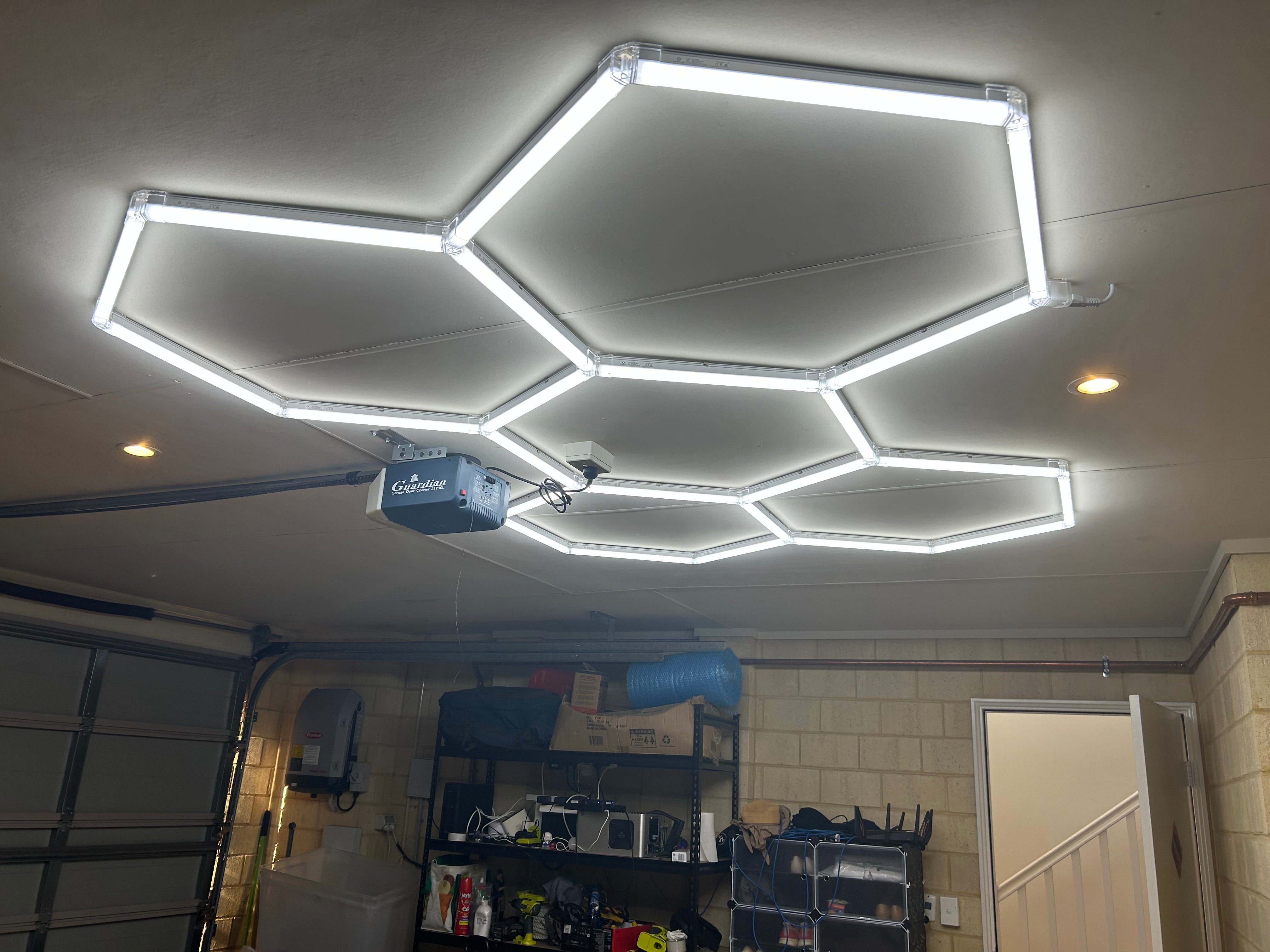 Five-grid hexagon LED lights installed on the ceiling of a home office creating a honeycomb pattern