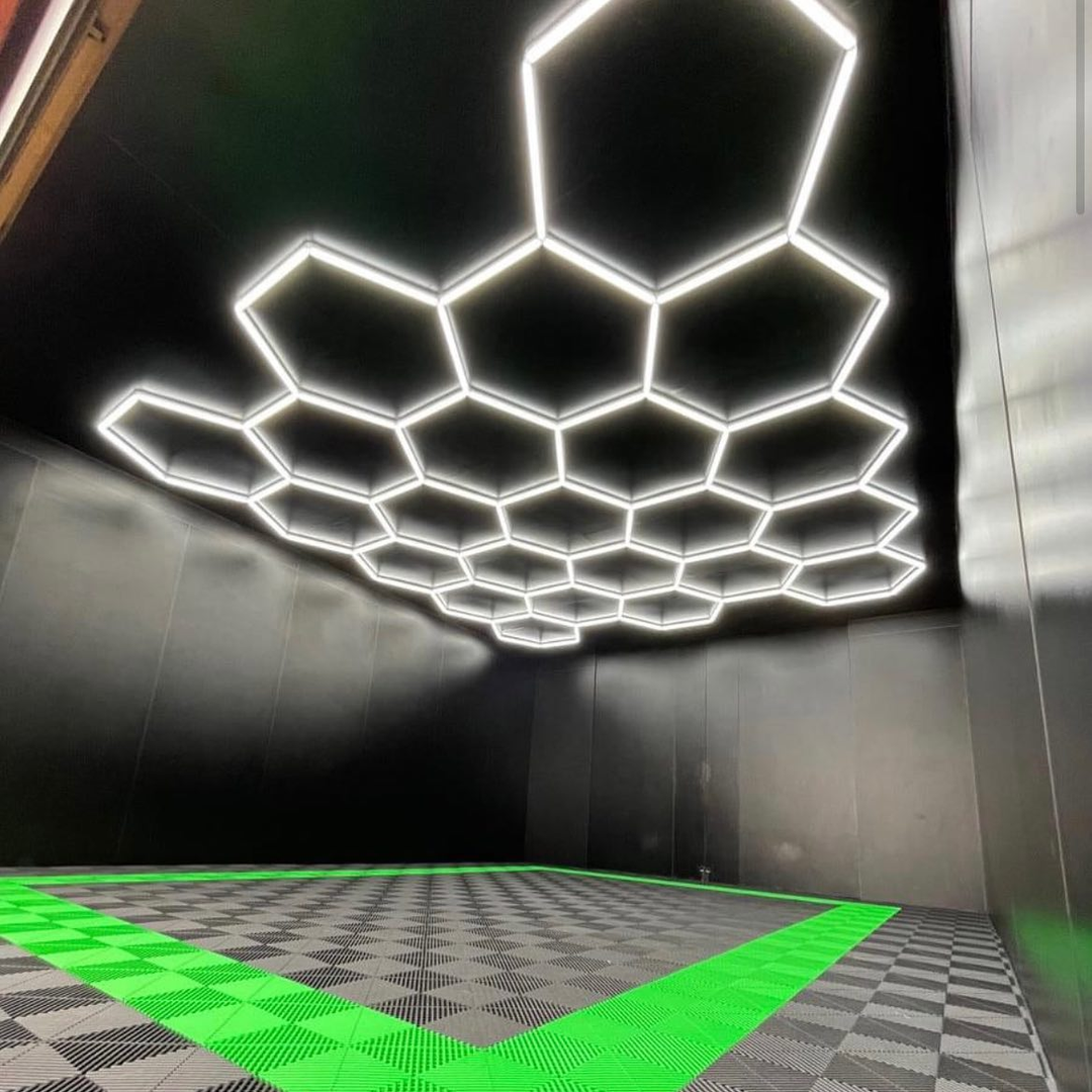 HEXLED hexagon ceiling lights mounted on a black double-garage ceiling, lighting both bays evenly